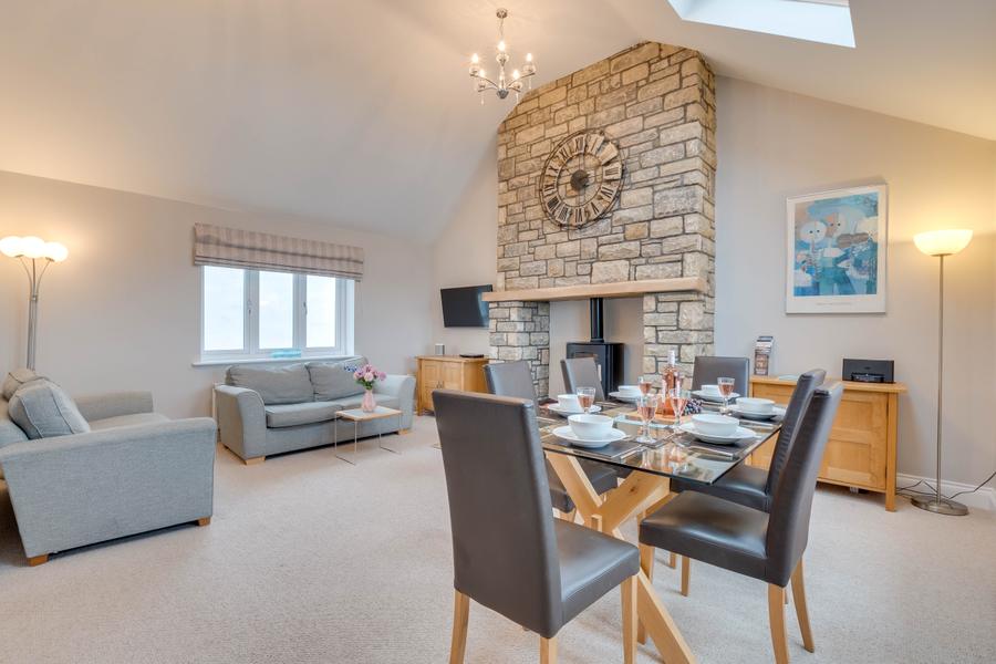 Sitting area with sofas and feature stone fireplace