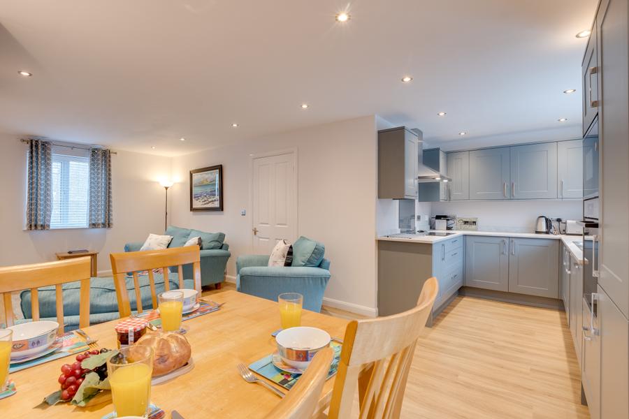Dining table laid for breakfast beside the kitchen