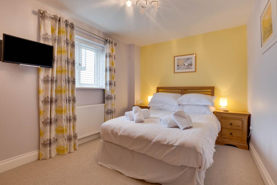 Ground floor double bedroom with wall mounted television