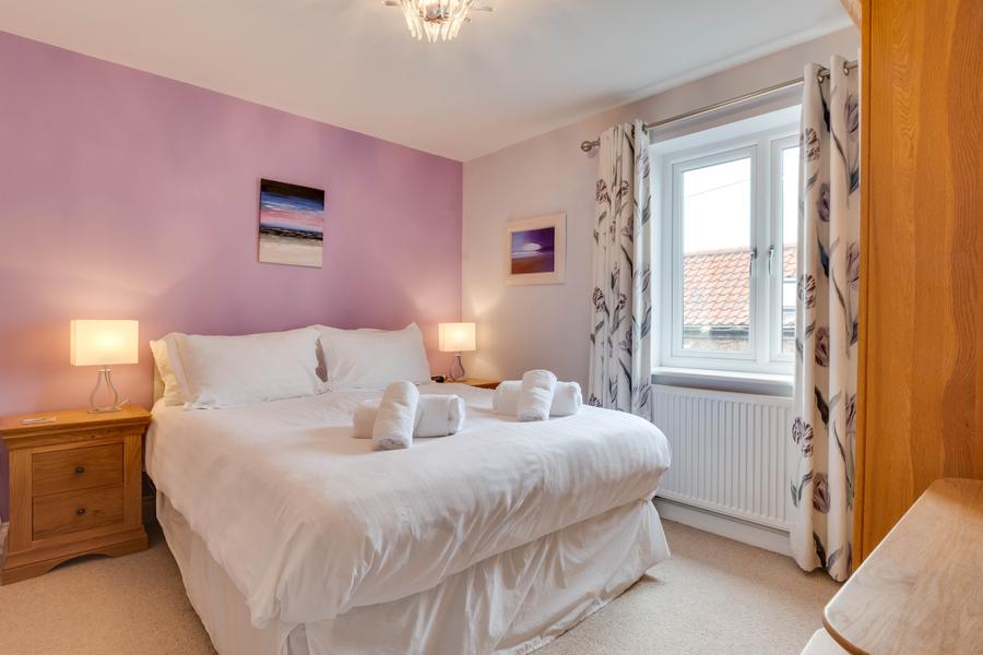 Double bedroom with bedside lamps and fresh towels