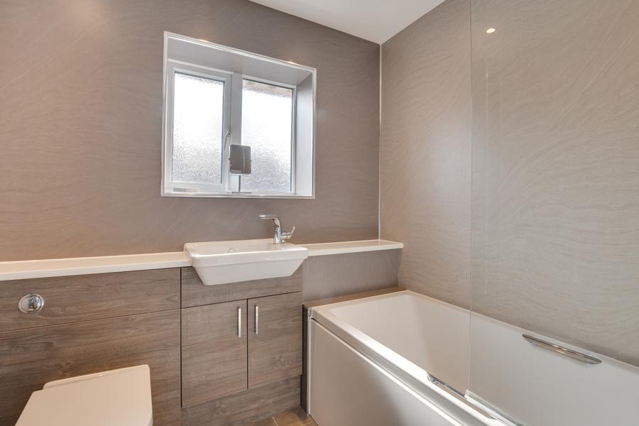 Family bathroom with bath, shower over, basin and WC
