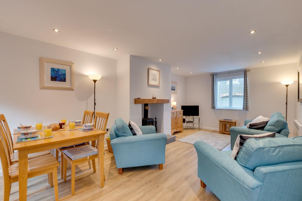 Open plan living and dining area with woodburning stove