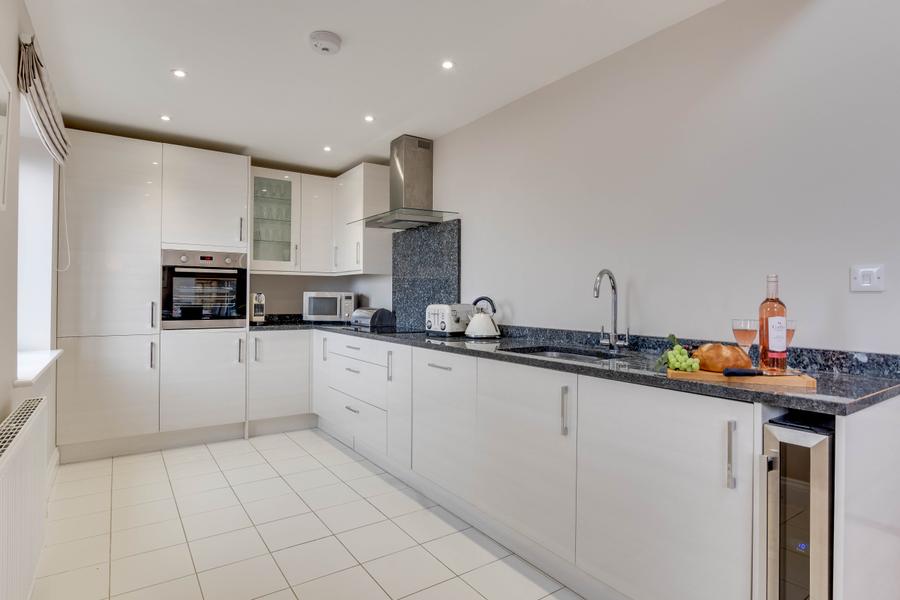 Fitted kitchen with electric oven, hob and wine chiller